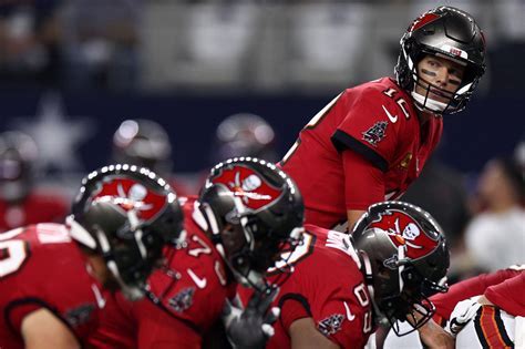 What Does QB Mean in Football? And Why Do Quarterbacks Always Wear Hats on the Sidelines?